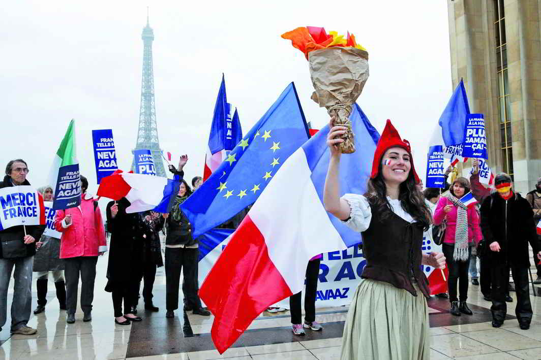 People celebrated Macron’s win with French and European flags and with placards that read: “France tells Hate: Never Again”. Photo: UNI