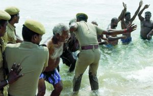 Police personnel removing agitating farmers who were staging a demonstration at Marina Beach in Chennai demanding that Tamil Nadu be declared drought-hit. Photo: UNI