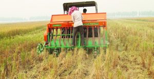 An attachment hitched to a tractor called Happy Seeder, which cuts 4-5 cm deep slits in the straw-covered fields and sows wheat in them along with fertilizer