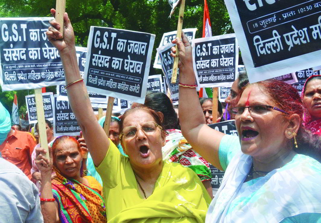 Congress workers raising slogans at a protest rally against GST in New Delhi. Photo: UNI