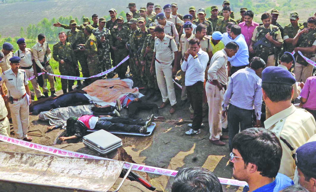 Cops at the site where eight SIMI men were shot after a Bhopal jailbreak. A recent report says SIMI activists are kept there in solitary confinement. Photo: UNI