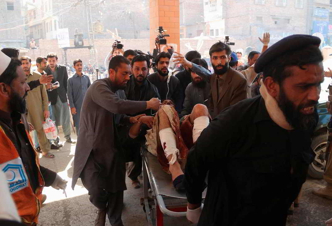 TRAGEDY STRIKES: Hospital workers transport a man injured in the Charsadda blast to the hospital in Peshawar, Reuters/UNI