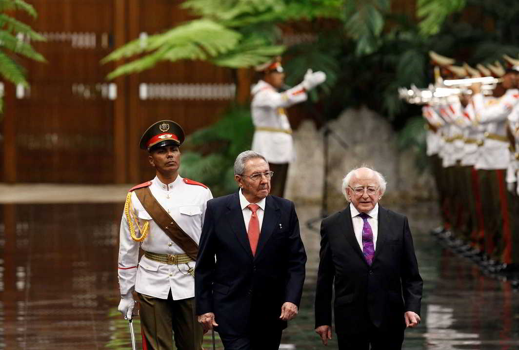 INVIGILATORS: Cuba's President Raul Castro (C) and his Irish counterpart Michael D Higgins (R) review an honor guard during a welcoming ceremony at the Revolution Palace in Havana, Cuba, Reuters/UNI