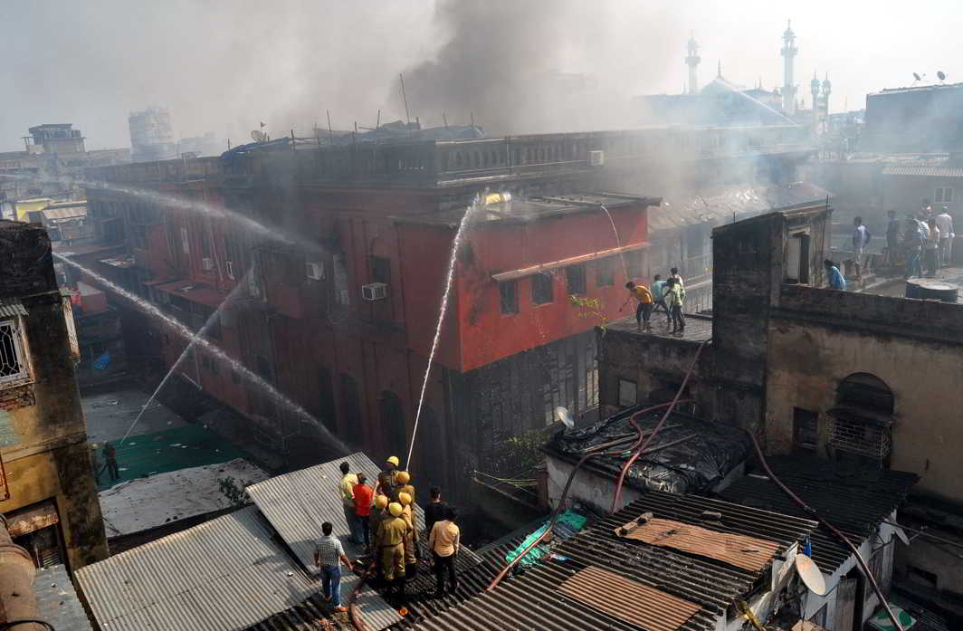 NO SMOKE WITHOUT FIRE: Firefighters try to control a major fire which broke out at a residential-cum-commercial building at Amratala Lane area under Burrabazar police station, in Kolkata, UNI