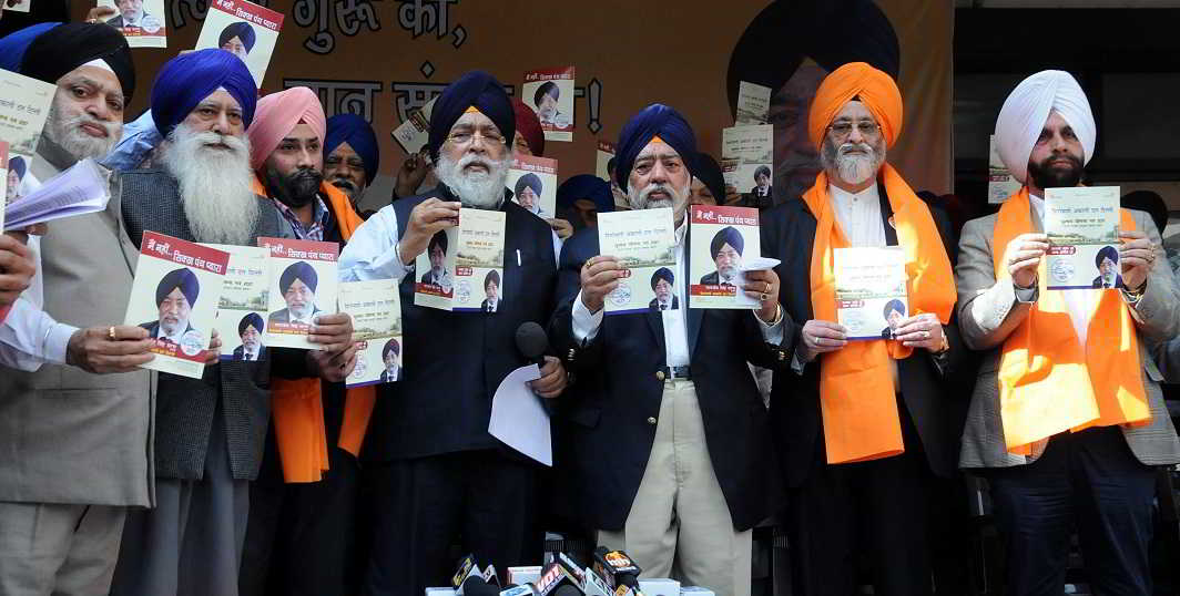 DECLARATION OF INTENT: Shiromani Akali Dal (SAD) Delhi president Paramjit Singh Sarna, with other members, releases the manifesto for the Delhi Sikh Gurdwara Management committee election, UNI