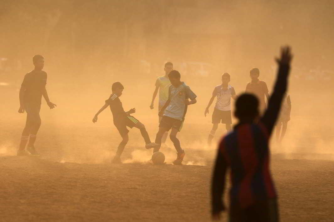 BEAUTIFUL GAME: Boys vie for the ball during soccer practice at a park in Mumbai, Reuters/UNI
