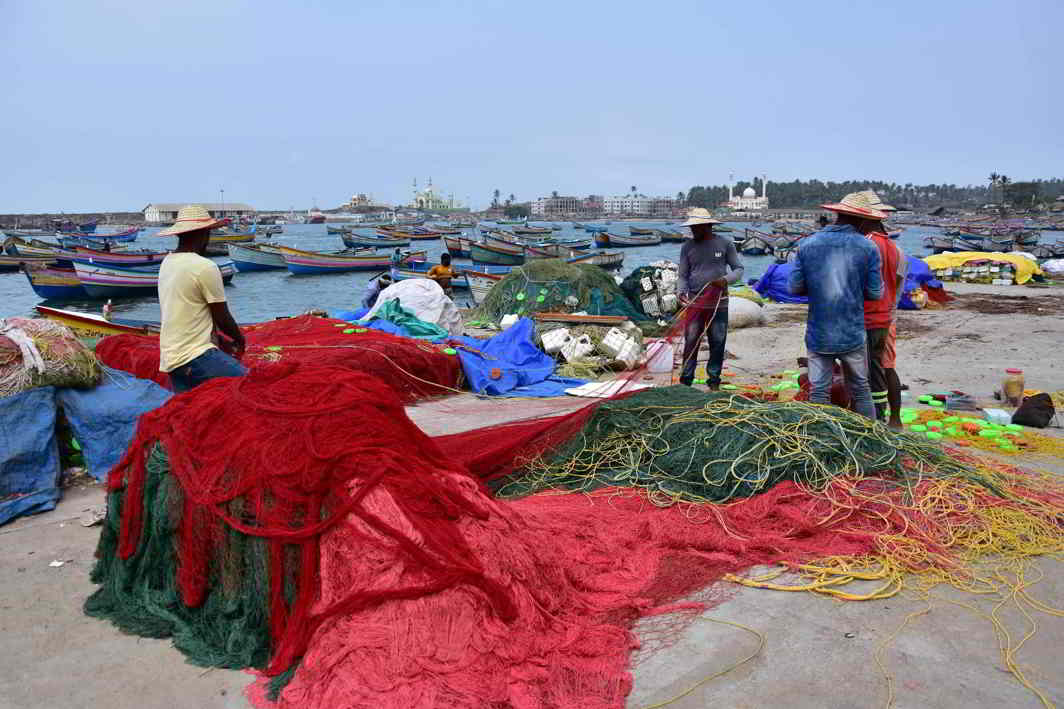 CAST AWAY: Fishermen prepare their nets before venturing into the sea at the Vizhinjam fishing harbour, UNI