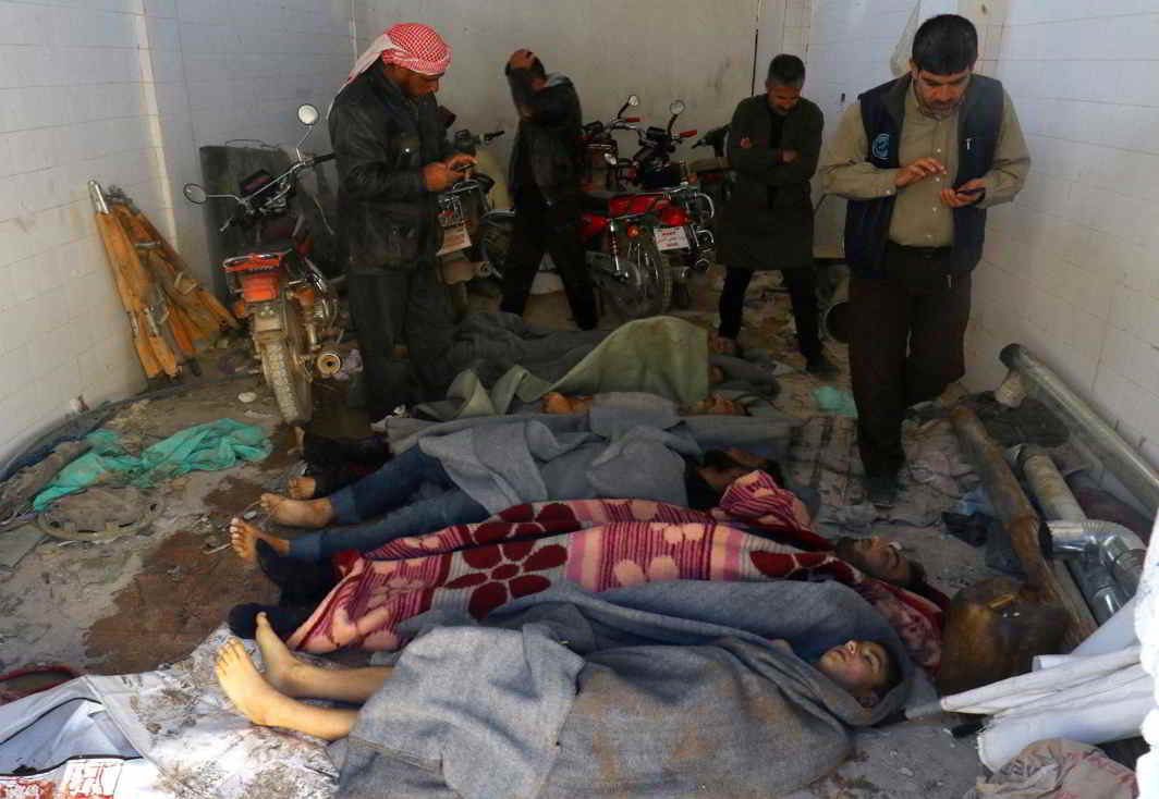 DASTARDLY ACT: Men gather near bodies, after a suspected gas attack in the town of Khan Sheikhoun in rebel-held Idlib, Syria, by government forces