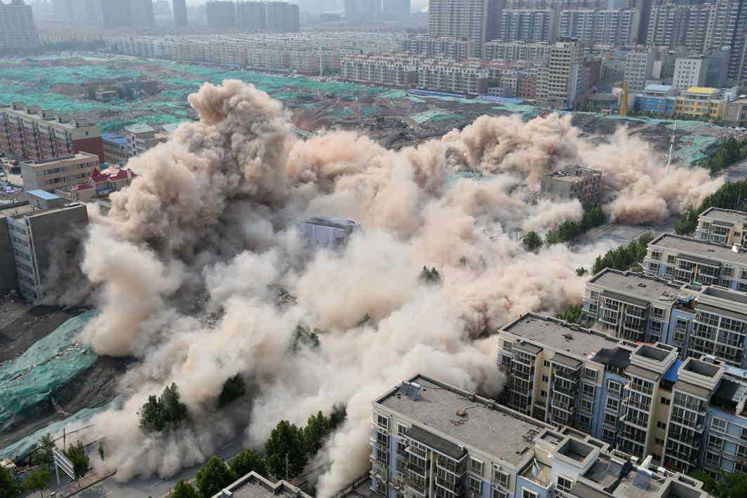 BOOM: Buildings crumble during a controlled implosion for the reconstruction of urban villages in Zhengzhou, Henan province, China, Reuters/UNI