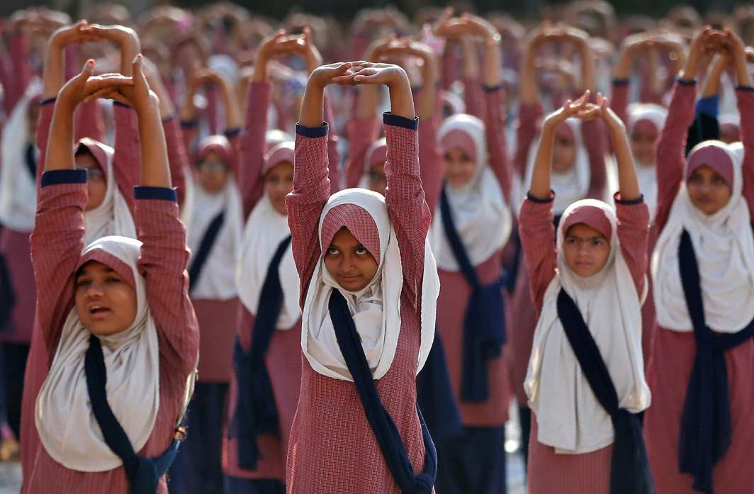 HEALTH IS WEALTH: Muslim girls practice yoga during a training session at a school compound ahead of International Yoga Day in Ahmedabad, Reuters/UNI