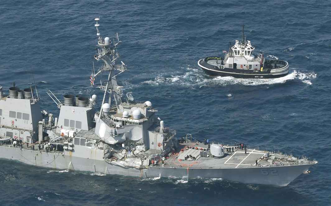 TAKING A HIT: The Arleigh Burke-class guided-missile destroyer USS Fitzgerald, damaged by colliding with a Philippine-flagged merchant vessel, is seen next to a tugboat (right) off Shimoda, Japan, Kyodo/Reuters/UNI