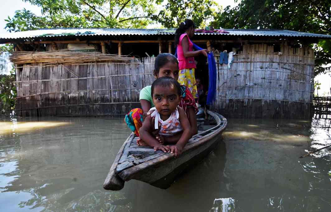 AFTER THE DELUGE: Villagers use a boat as they try to move to safer places at a flood-affected village in Darrang district in the northeastern state of Assam, Reuters/UNI