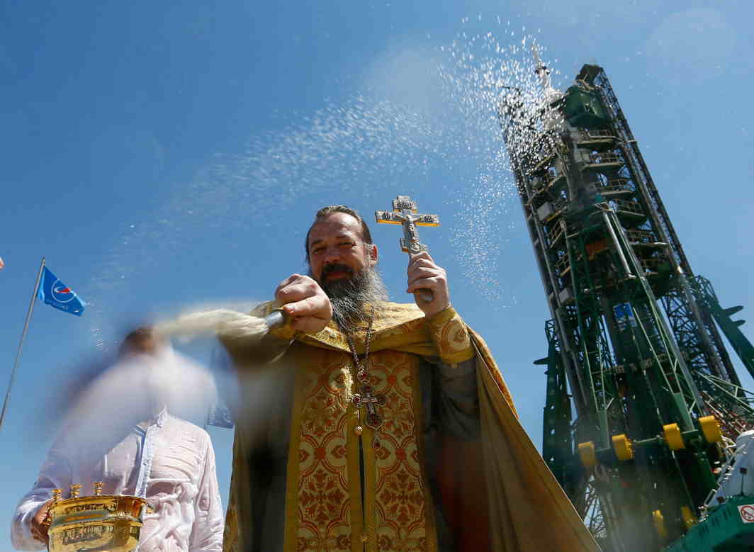 ALL IN THE MIND: An Orthodox priest conducts a blessing in front of the Soyuz MS-05 spacecraft set on the launchpad ahead of its upcoming launch, at the Baikonur Cosmodrome in Kazakhstan, Reuters/UNI