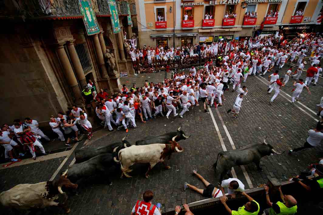 ROUGH AND TUMBLE: A runner lies on the floor after getting knocked down during the second running of the bulls at the San Fermin festival in Pamplona, Spain, Reuters/UNI