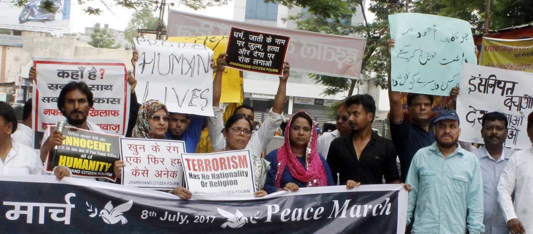 WHY CAN’T WE BE FRIENDS? Muslims holding placards and banners take out a peace march against the killing of their brethren, outside Raj Bhawan in Ranchi, UNI