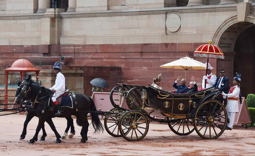 HELLO, GOODBYE: Incumbent president Ram Nath Kovind and outgoing president Pranab Mukherjee take a buggy ride after the guard of honour ceremony at Rashtrapati Bhavan, in New Delhi, PIB
