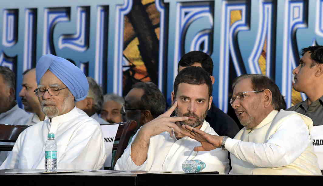 LIKEMINDED? Janata Dal (United) leader Sharad Yadav in conversation with Congress vice-president Rahul Gandhi during the 'Save Composite Culture Conference' in New Delhi. Former Prime Minister Manmohan Singh is also seen, UNI