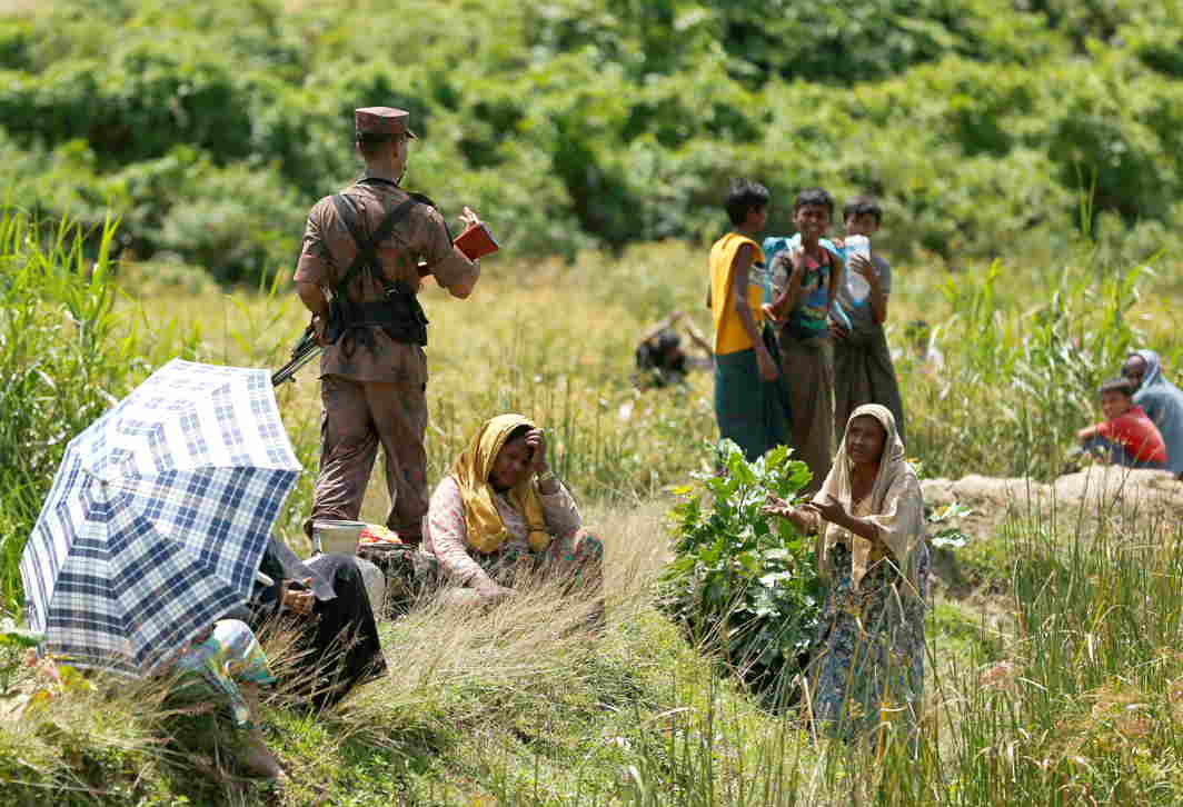 LIKE A ROLLING STONE: A Rohingya woman urges the member of Border Guard Bangladesh not to return them back to Myanmar, in Cox s Bazar, Bangladesh, Reuters/UNI