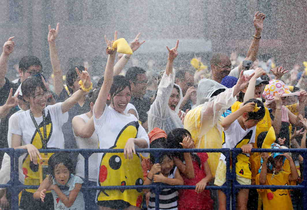 SIMPLE PLEASURES: Attendants react to water spray at a splash show and Pokemon Go Park event in Yokohama, Japan, Reuters/UNI