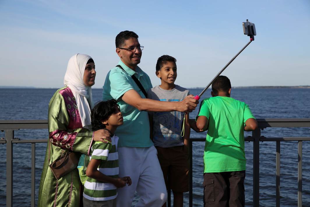 FAMILY MOMENTS: A Muslim family uses a selfie stick to take photos after Eid al-Adha prayers in Bensonhurst Park in Brooklyn, New York, Reuters/UNI