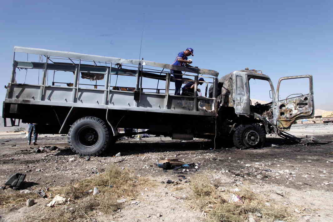 VEHICLE OF DEATH: Rescue workers inspect a truck after a blast in Quetta, Pakistan, Reuters/UNI