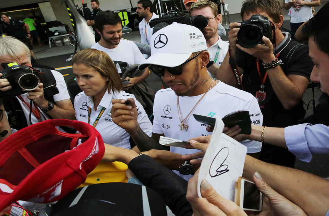 VROOM GOD: Mercedes' Lewis Hamilton of Britain autographs a cap for a fan ahead of the Mexican Grand Prix at Autodromo Hermanos Rodriguez in Mexico City, Mexico, Reuters/UNI