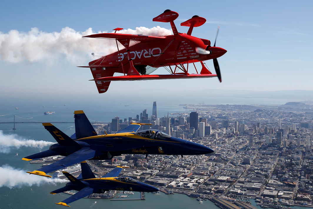 NOTHING BY CHANCE: The US Navy Blue Angels flight demonstration squadron and Team Oracle aerobatics pilot, Sean Tucker, fly over San Francisco Bay during a photo flight ahead of Fleet Week in San Francisco, California, US, Reuters/UNI