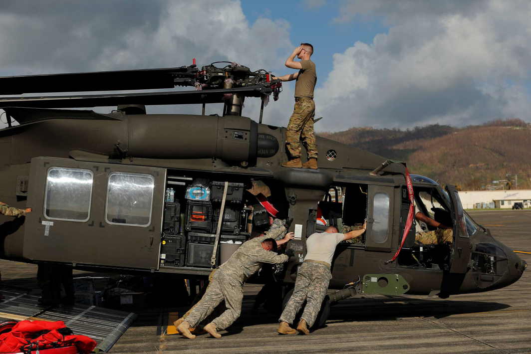 HELPING HAND: Soldiers with the US Army's 1st Armored Division, Combat Aviation Brigade, work to unload a UH-60 Blackhawk helicopter from a US Air Force C-5 Galaxy to aid in recovery efforts following Hurricane Maria in Roosevelt Roads, Puerto Rico, Reuters/UNI