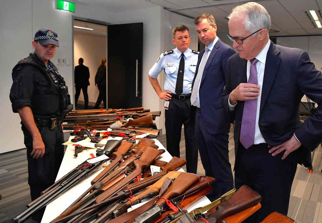 GUNS UNDER CONTROL: Australian Prime Minister Malcolm Turnbull with Australian Federal Police Commissioner (AFP) Andrew Colvin and Australian Justice Minister Michael Keenan at firearms on display in Sydney, Australia, Reuters/UNI