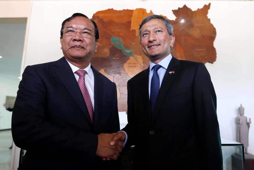 FOSTERING TIES: Singapore's Foreign Minister Vivian Balakrishnan (right) shakes hands with his Cambodian counterpart Prak Sokhon before a meeting at the Ministry of Foreign Affairs and International Cooperation in Phnom Penh, Cambodia, Reuters/UNI