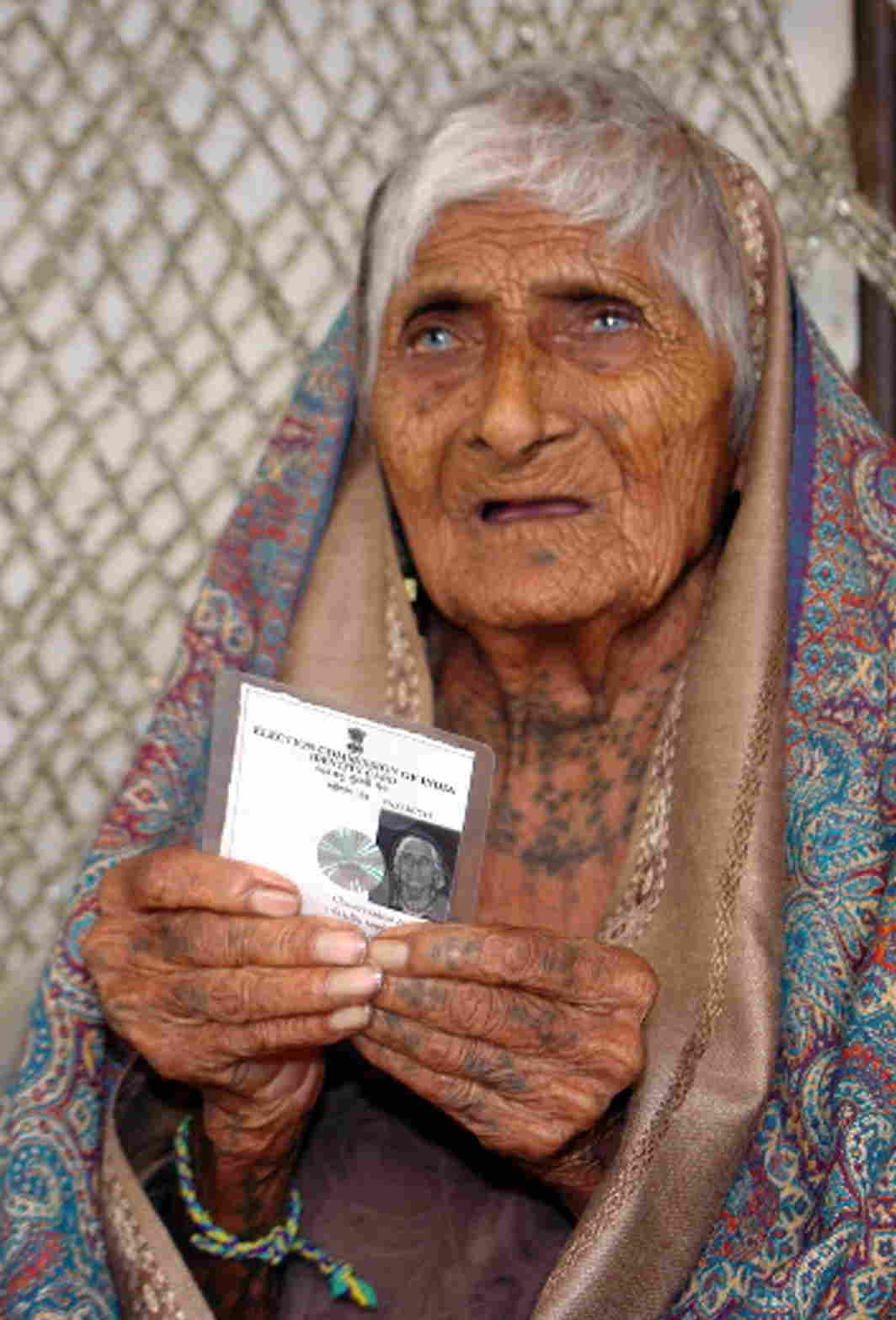 STAR OF THE SHOW: One-hundred-and-twenty-six-year-old Ajiben shows off her voter's identity card at a polling centre prior to casting her vote for the Gujarat assembly election in Rajkot, UNI