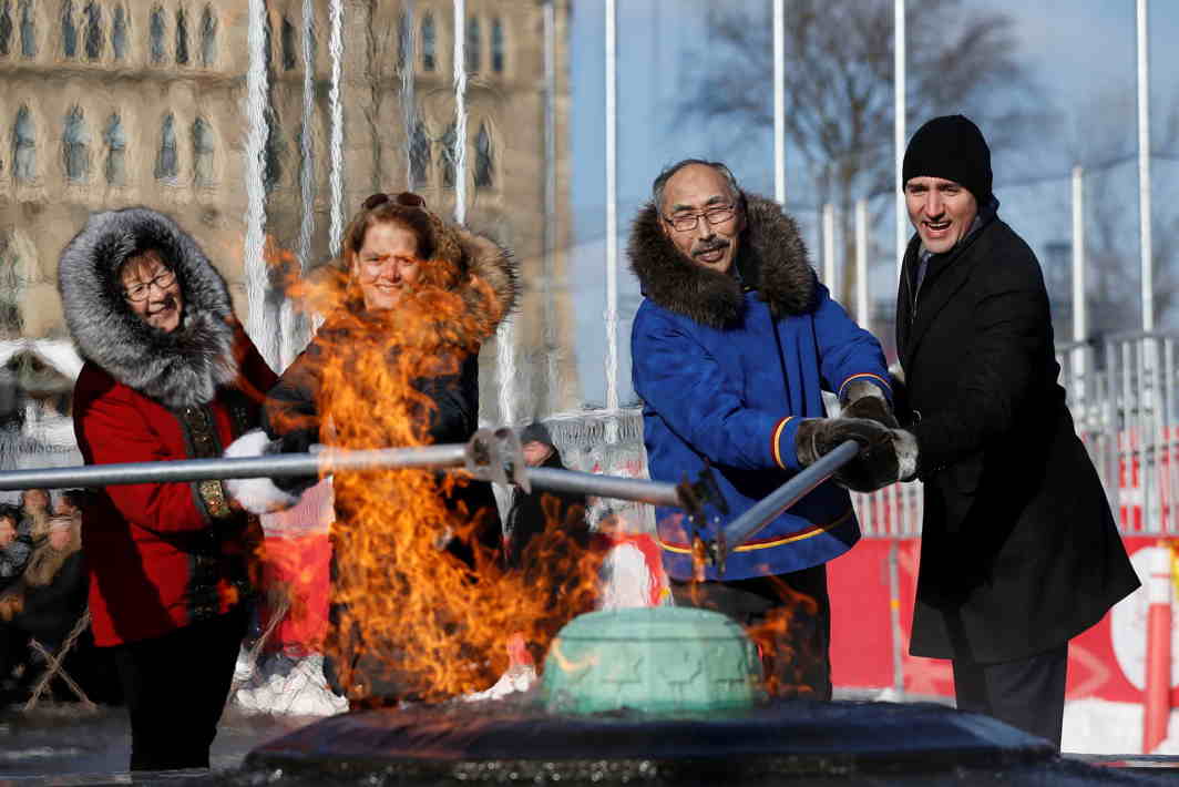 STAND TOGETHER: Canada's Prime Minister Justin Trudeau (right) helps light the Centennial Flame with Nunavut's Premier Paul Quassa (second right), Governor General Julie Payette (second left) and Nunavut's Commissioner Nellie Kusugak, during a ceremony on Parliament Hill in Ottawa, Ontario, Canada, Reuters/UNI