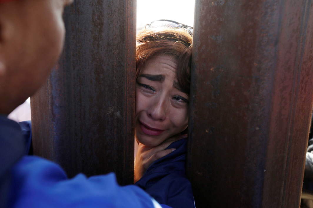 DYING DREAM: A woman cries as 'Dreamers' meet with relatives during the 'Keep Our Dream Alive' binational meeting at a new section of the border wall on the US-Mexico border in Sunland Park, US, opposite the Mexican city of Ciudad Juarez, Mexico, Reuters/UNI