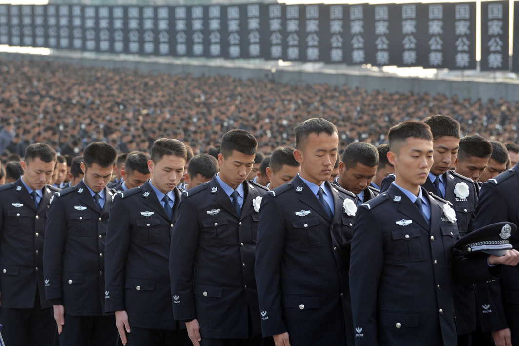 CHILLING MEMORY: Police pay a silent tribute during a memorial ceremony to mark the 80th anniversary of the 1937 Nanjing massacre, on the National Memorial Day in Nanjing, Jiangsu province, Reuters/UNI