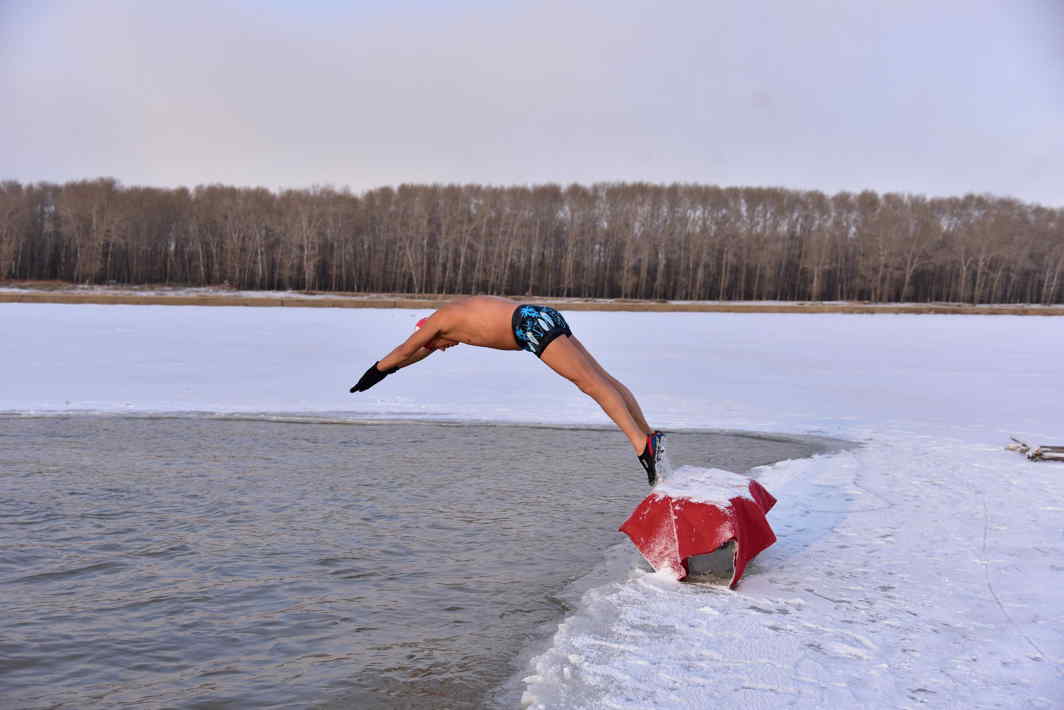 BRAVEHEART: A winter swimmer dives into the icy water of Songhua river in Songyuan, Jilin province, China, Reuters/UNI