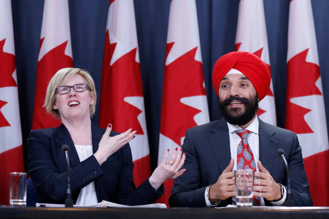 MEET THE PRESS: Canada's Public Works Minister Carla Qualtrough (L) and Innovation Minister Navdeep Bains react during a news conference in Ottawa, Ontario, Canada, Reuters/UNI