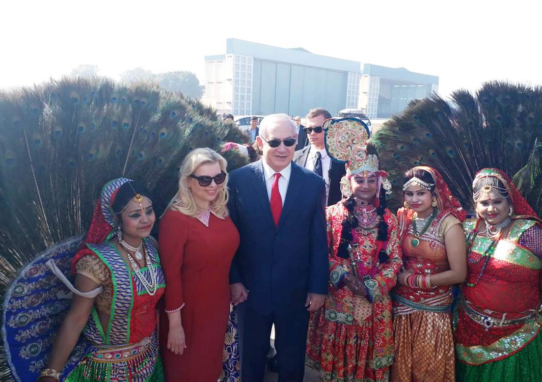 AUGUST COMPANY: Israel Prime Minister Benjamin Netanyahu with wife Sara with folk artistes, pose for photographers during his visit in Agra, UNI