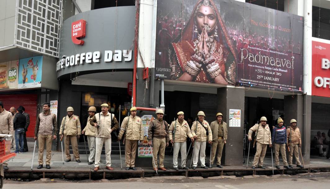 ON GUARD: Police personnel deployed outside Novelty theatre as a precautionary measure during the release of the film, “Padmavat”, in Lucknow, UNI