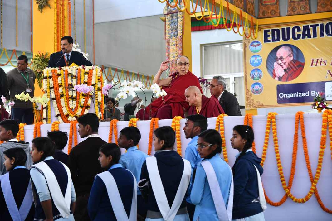 LESSONS OF THE SOUL: Tibetan spiritual leader, The Dalai Lama, interacts with school students at Kalachakra ground in Bodhgaya, UNI