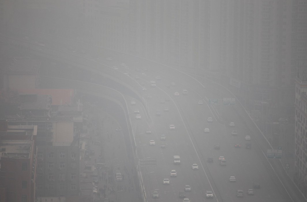 IMPREGNABLE HAZE: Vehicles drive on a highway amid smog in Zhengzhou, Henan province, China, Reuters/UNI