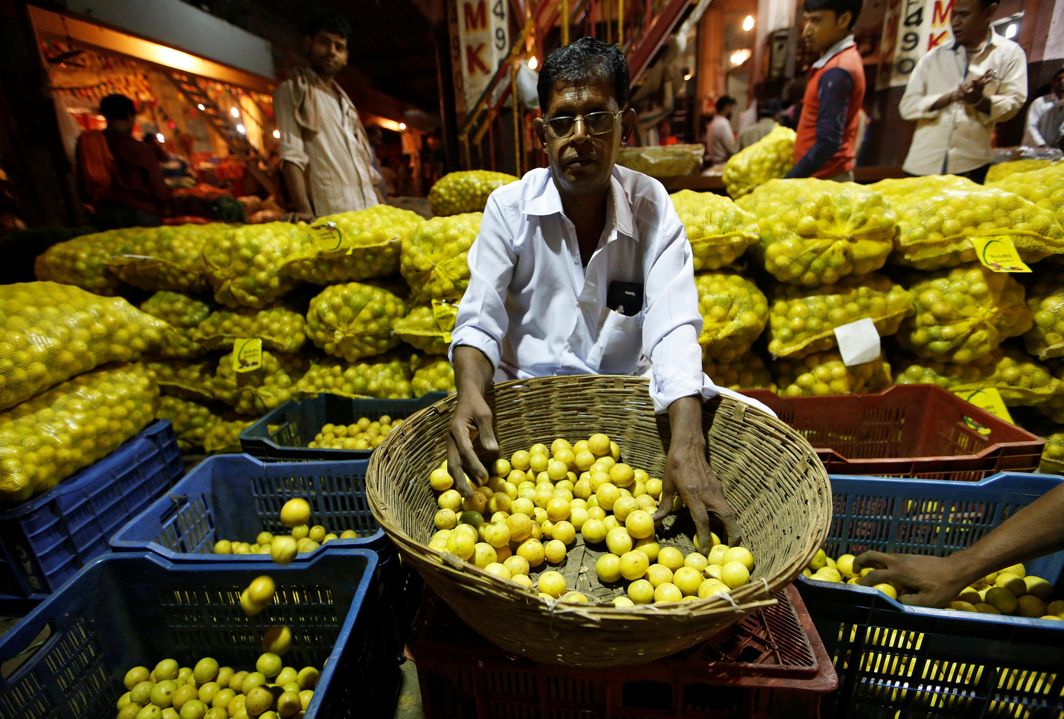 FOR A PENNY: A worker sorts lemons at a wholesale market in Mumbai, India, Reuters/UNI