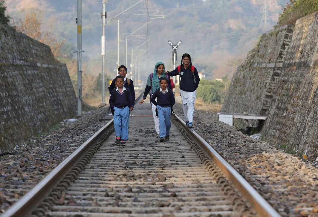 DAILY COMMUTE: Schoolchildren walk on a railway track on the outskirts of Jammu, Reuters/UNI