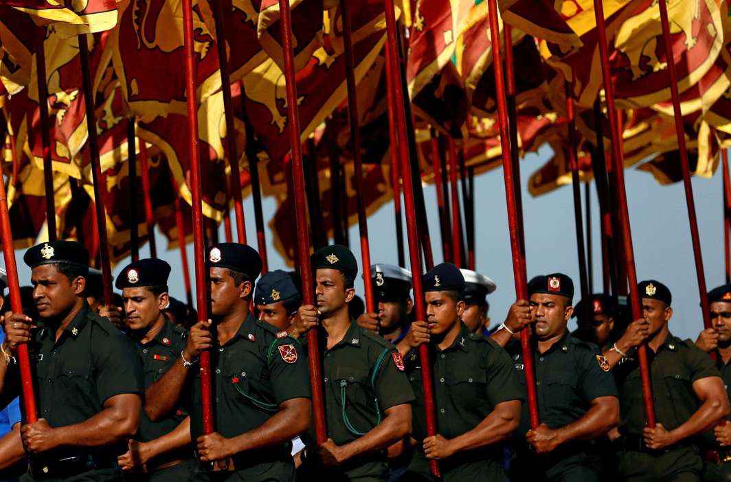 PATRIOTIC ZEST: Sri Lankan soldiers march with the national flags during a rehearsal parade ahead of the country’s 70th Independence Day, in Colombo, Reuters/UNI