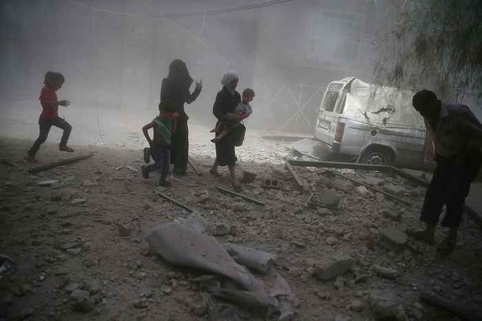 HUMANITARIAN DISASTER: People run for cover during an airstrike; courtesy Reuters
